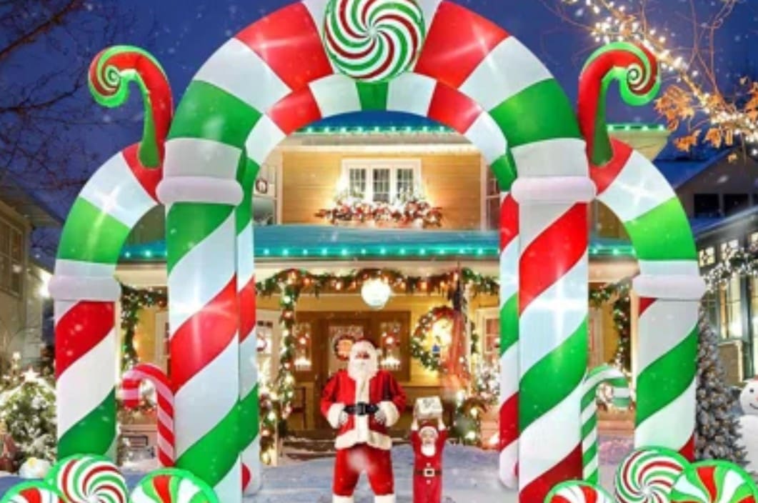 A large inflatable santa claus and candy cane arch.